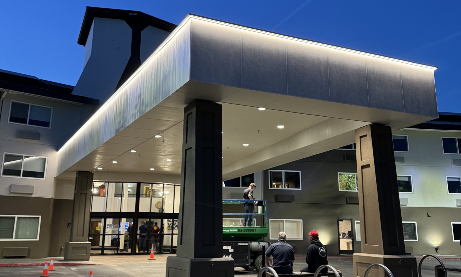 Renovated hotel entrance at dusk with new LED cove lighting along the porte-cochère