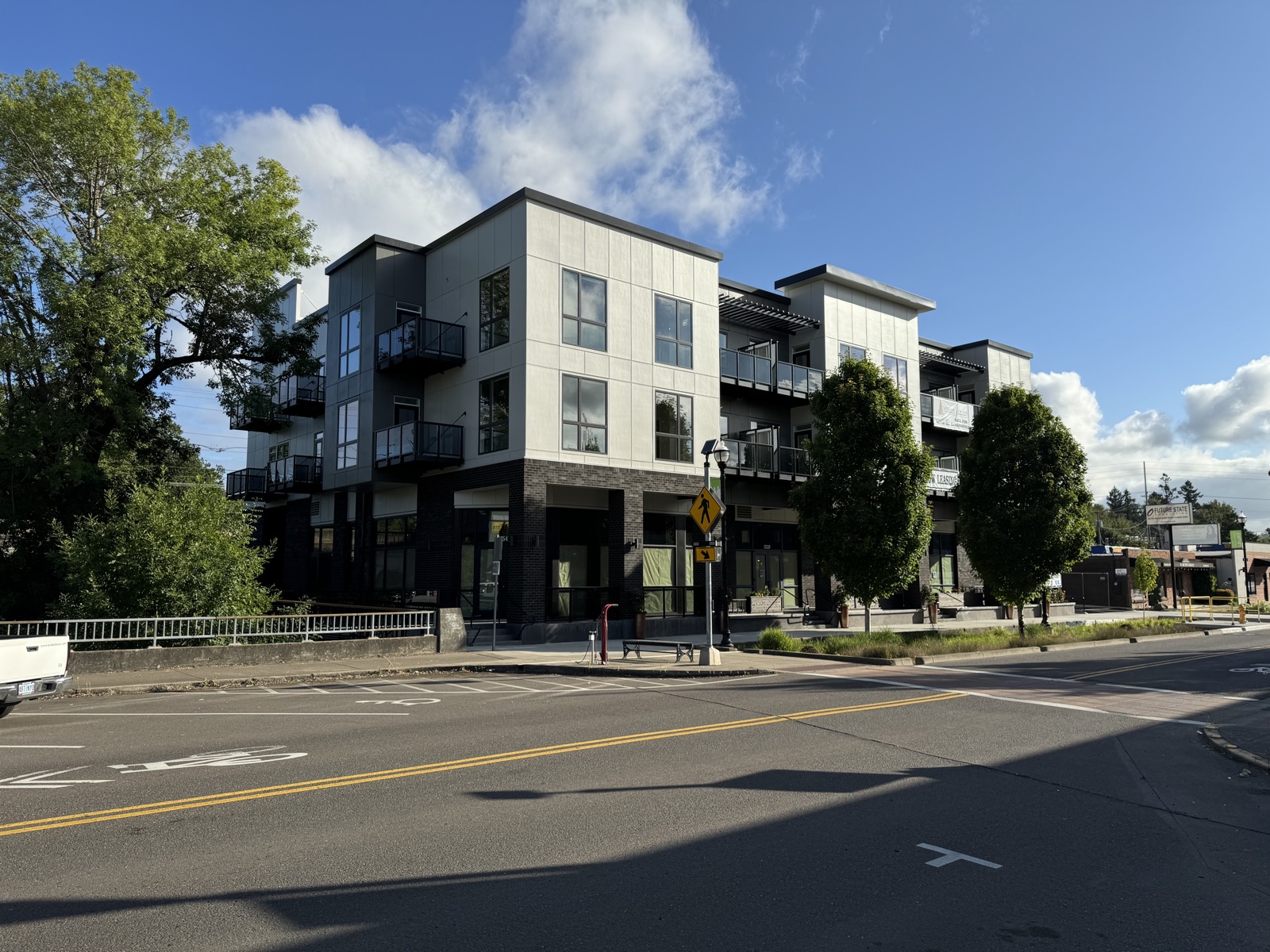 The Roastery by Ava — completed three-story mixed-use building in downtown Tigard with ground-floor tenant spaces and apartments above